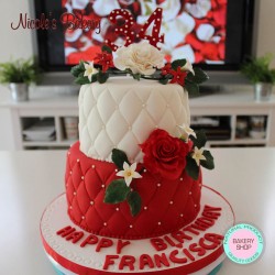 Elegant white and red cake with gum paste roses. 
